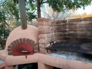 a brick oven sitting next to a brick wall at Arcadia 1 in Santiago