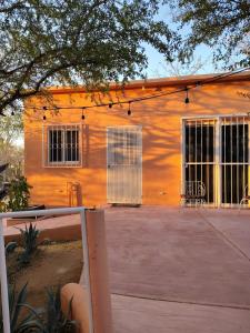 an orange building with windows and a patio at Arcadia 1 in Santiago +7 photos