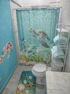 a bathroom with a sea turtle shower curtain at Arcadia 1 in Santiago