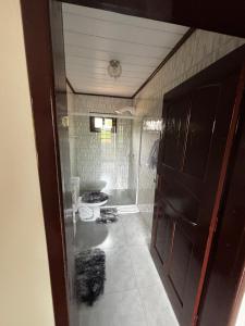a bathroom with a toilet and a door in it at Casa na Natureza Próx Pomerode e Timbó in Rio dos Cedros +15 photos