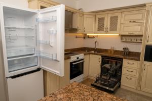 a kitchen with an open refrigerator and an oven at BNM Base Camp - Ulaanbaatar in Ulaanbaatar