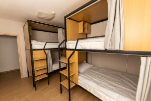a room with three bunk beds and a bed at BNM Base Camp - Ulaanbaatar in Ulaanbaatar