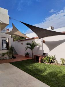 a white house with a yard with green grass at Villas Carlota Cancún in Cancún