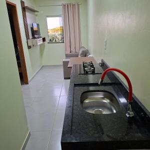 a bathroom with a sink in the middle of a room at Apartamento Selva in Itaquatiara