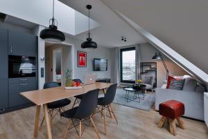 a dining room and living room with a table and chairs at Bett&Bude Boardinghouse in Westerland