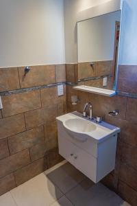a bathroom with a sink and a mirror at Cabaña Piedra y Sol de CACHI in Cachí +7 photos