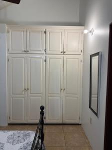 a room with white cabinets and a mirror at Driftwood 85 in Canaan +23 photos