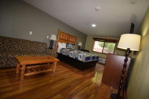 a bedroom with a bed and a table in a room at Nisqually Lodge in Ashford