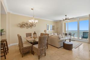 a living room with a couch and a table and chairs at PRIVATE BEACH FRONT LUXURY CONDO, AMAZING VIEWS, INDiGO E, 5-STAR, 2 BALCONIES , PREFERRED PARTNER PRG in Pensacola