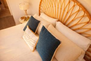 a pile of pillows sitting on a bed at Newly Restyled Resort 2 Bedroom Unit Oaks Pacific Blue in Salamander Bay +22 photos