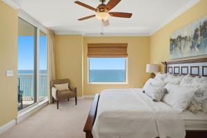 a bedroom with a bed and a ceiling fan at PRIVATE BEACH FRONT LUXURY CONDO, AMAZING VIEWS, INDiGO E, 5-STAR, 2 BALCONIES , PREFERRED PARTNER PRG in Pensacola +40 photos