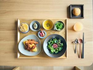 a tray with plates of food on a table at Hotel Miyam Matsubarako in Yanaike +30 photos