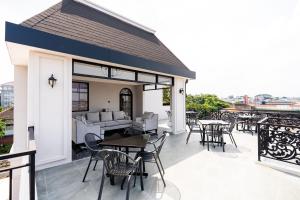 a patio with tables and chairs on a roof at Casa De Zea by AKA in Yogyakarta