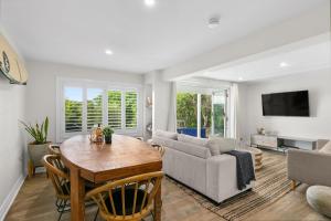 a living room with a table and a couch at Blue View Gerringong in Gerringong +8 photos