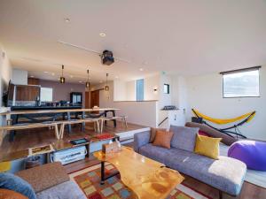 a living room with a couch and a table at Private Ocean Resort YUUNAGI in Awaji