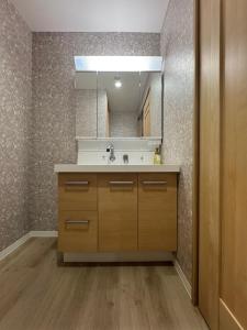 a bathroom with a sink and a mirror at Ruka Hotel Tennoji in Osaka +62 photos