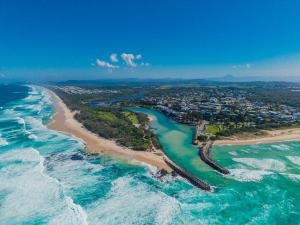 an aerial view of a beach and the ocean at Coastal Breeze 12a - Kingscliff Studio in Kingscliff +4 photos