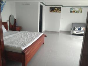 a bedroom with a bed and a mirror on the wall at Hotel Long Quân in Thanh Hóa