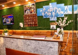 a bar in a restaurant with a green wall at Hotel MountMemory , Barkot-Yamunotri in Barkot +23 photos