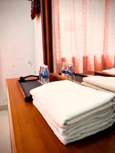 a table with towels and bottles of water on it at Mama Nusantara Hotel in Jertih +12 photos