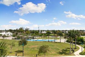 a park with a swimming pool and palm trees at Spacious Condo - 2 King Suites - Close to Beaches in Marco Island