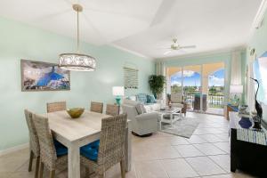 a dining room and living room with a table and chairs at Spacious Condo - 2 King Suites - Close to Beaches in Marco Island +15 photos
