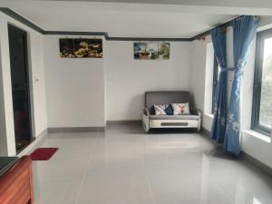 a living room with a couch and a window at Hotel Long Quân in Thanh Hóa