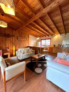 a living room with couches and a table and a kitchen at El Descanso del Quijote in Riñinahue +95 photos