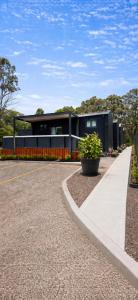 a building with a walkway in front of it at Tiny Home in Casula Station