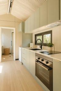 a kitchen with a sink and a stove at Tiny Home in Casula Station