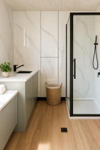 a bathroom with a shower and a sink at Tiny Home in Casula Station