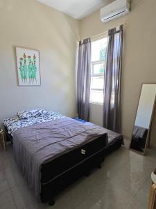 a bedroom with a bed and a window at Laguna Ijen Homestay in Banyuwangi