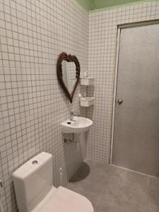 a bathroom with a toilet and a heart on the wall at Laguna Ijen Homestay in Banyuwangi +13 photos
