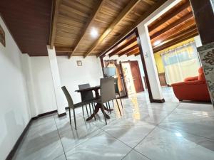 a living room with a table and chairs and a couch at Casa Gavril Escazu in San Antonio +12 photos
