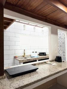 a kitchen with a counter with a sink and a window at Casa Gavril Escazu in San Antonio