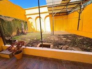 a yellow building with a potted plant in a courtyard at Casa Gavril Escazu in San Antonio
