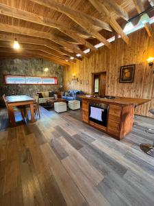 a large living room with wooden floors and a fireplace at El Descanso del Quijote in Riñinahue