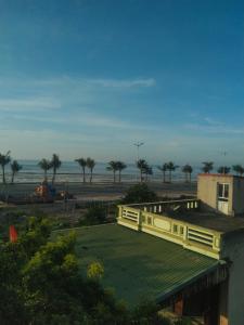 a view of a building and a beach with trees at Flamingo ibza001 in Thanh Hóa