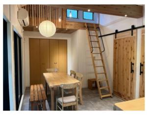 a room with a wooden table and a ladder at Forest 99 in Nasushiobara