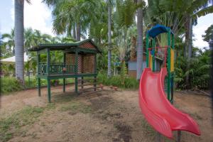 a playground with a red slide and a gazebo at Ivanhoe Resort in Kununurra