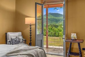 a bedroom with a bed and a window with a view at Glenrock Homestead in Bulga