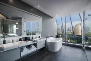 a bathroom with two sinks and a large window at Discovery SCBD Jakarta in Jakarta +25 photos