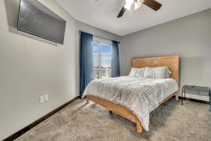 a bedroom with a bed and a window at Poolside Retreat at Bridges Bay in Arnolds Park