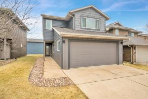 a house with a garage and a driveway at Poolside Retreat at Bridges Bay in Arnolds Park