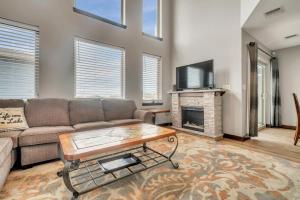 a living room with a couch and a fireplace at Poolside Retreat at Bridges Bay in Arnolds Park