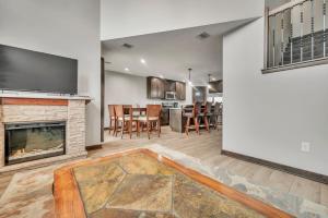 a living room with a fireplace and a dining room at Poolside Retreat at Bridges Bay in Arnolds Park
