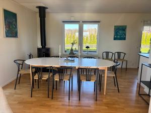 a dining room with a table and chairs at Ausås Ängelholm in Ängelholm