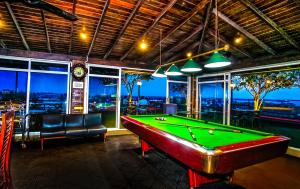 a pool table in a room with a view of the city at Arama Transit Hotel in Katunayaka