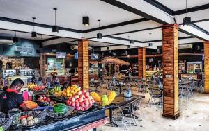 a restaurant with tables filled with fruits and vegetables at Arama Transit Hotel in Katunayaka
