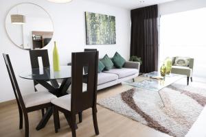 a living room with a glass table and a couch at Miraflores Nest Upper Pardo in Lima +77 photos